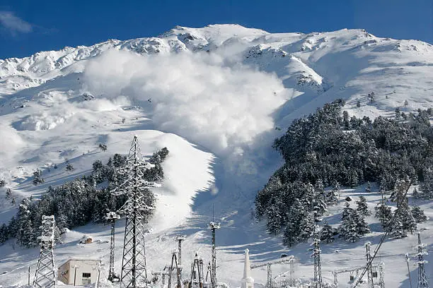 Dry snow avalanche with a powder cloud close to the village Terskol, Elbrus region,Caucasus.