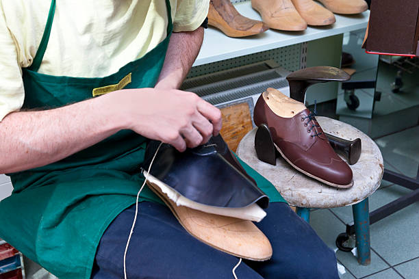 Handmade Shoe Shoemaker manufactures the shank of a shoe. shoe mold stock pictures, royalty-free photos & images