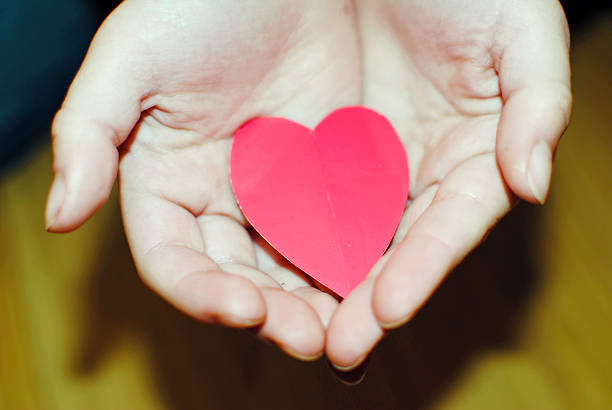 istock hands holding paper heart 533462989