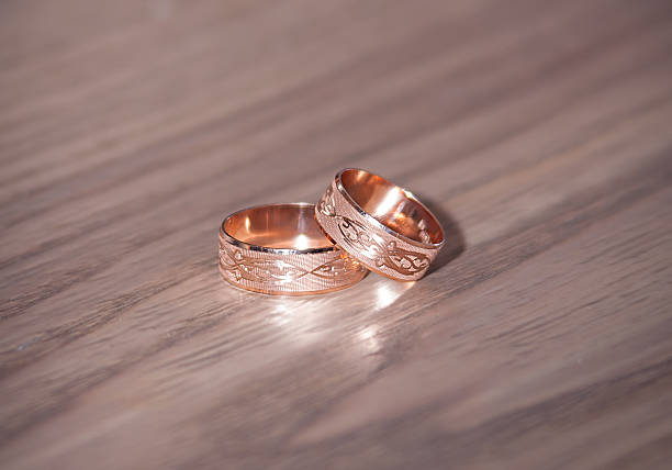 istock gold wedding rings on the brown table 533463151