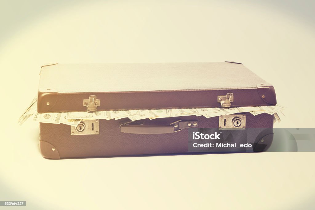 Luggage full of money Luggage full of money in retro-style 2015 Stock Photo