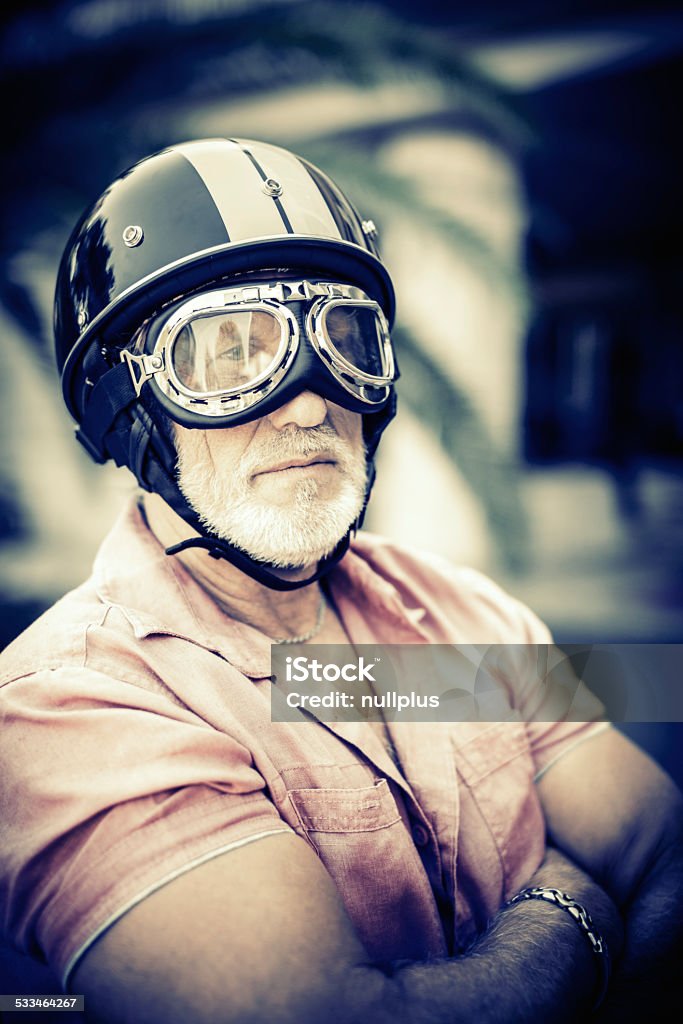 senior racing driver portrait of a senior racing driver wearing vintage helmet and glasses Race Car Driver Stock Photo
