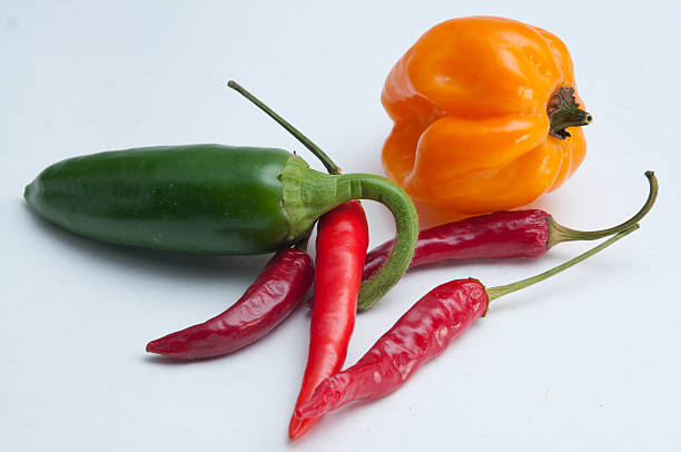 Eat me spicy Hot chili mix on white background anaheim pepper photos stock pictures, royalty-free photos & images