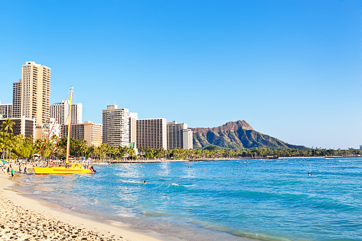 Popular tourist destination of Waikiki Beach with Diamond Head in the background in Honolulu, Oahu, Hawaii, USA.