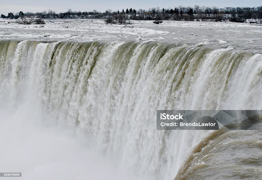 Winter Precipice - Niagara Falls Canada The magnificent Niagara Falls photographed in winter, emphasis on precipice.  A high key image in color. At The Edge Of Stock Photo