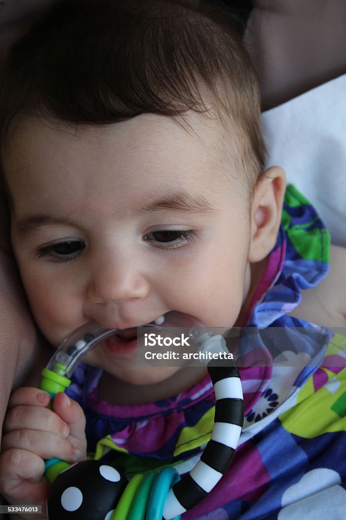 baby teething her toy 2015 Stock Photo