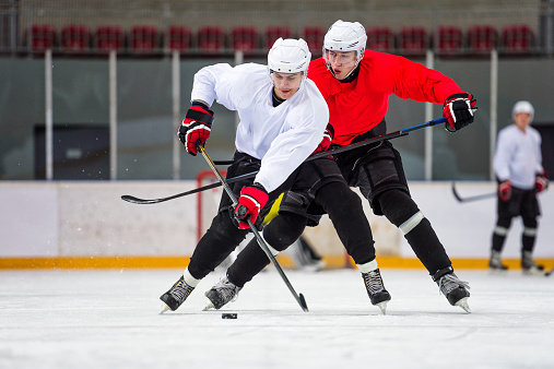Front view of two ice hockey players at rough game
