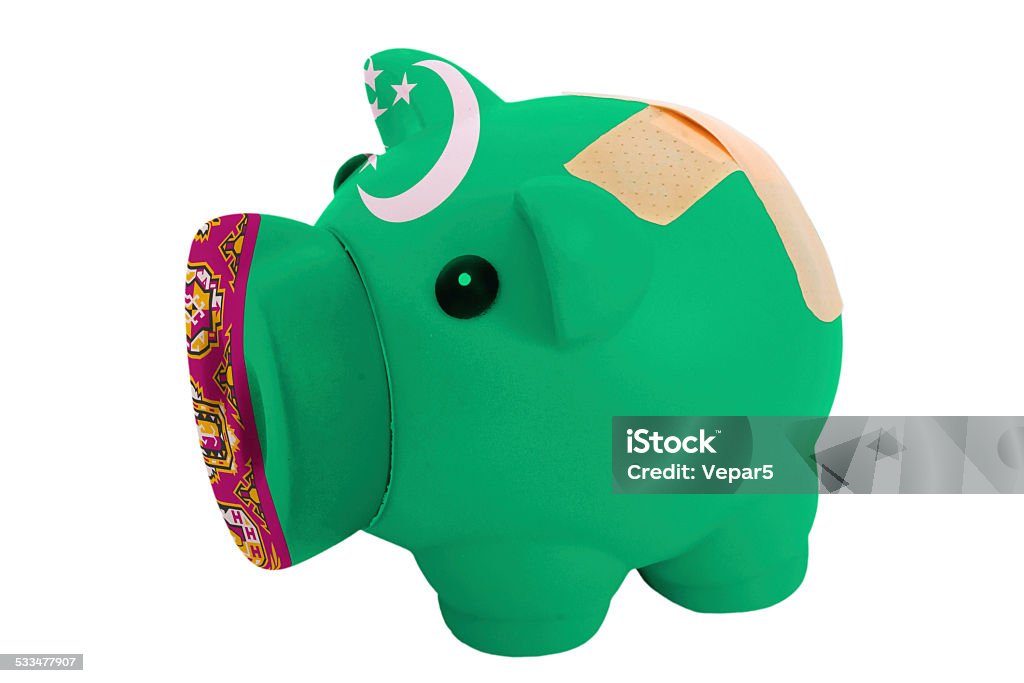 closed piggy rich bank with bandage in colors of turkmenistan empty poor man piggy rich bank in colors national flag of turkmenistan on white 2015 Stock Photo