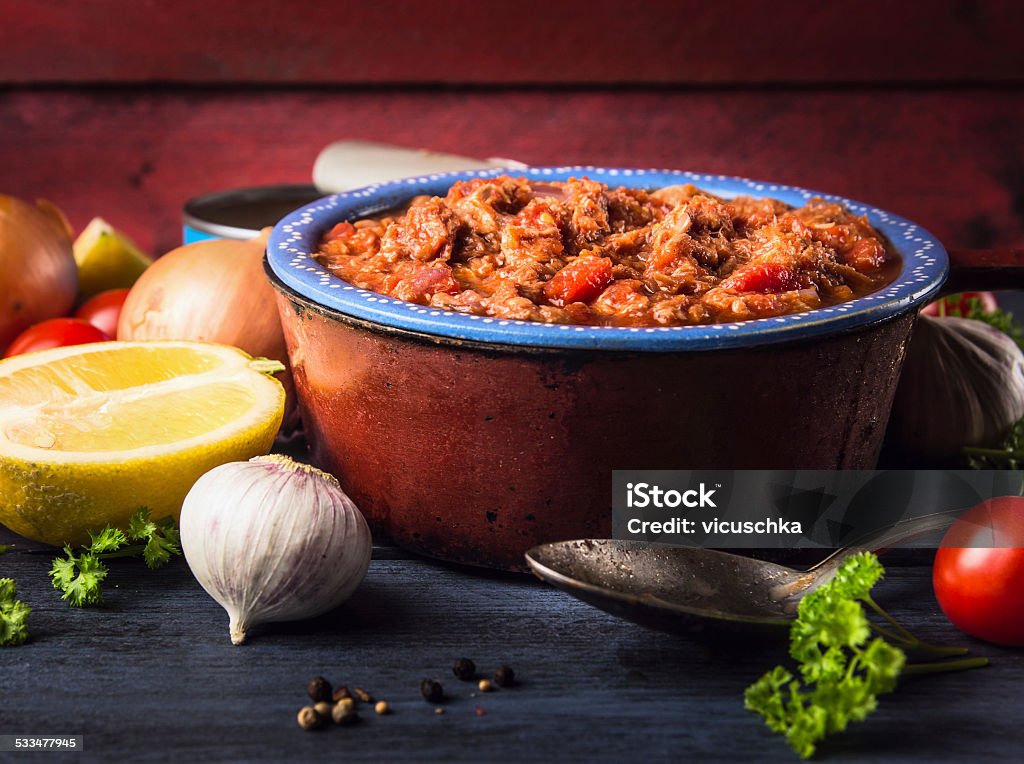 tomato sauce with tuna fish in old pot, spoon , spices tomato sauce with tuna fish in old pot with spoon and spices 2015 Stock Photo