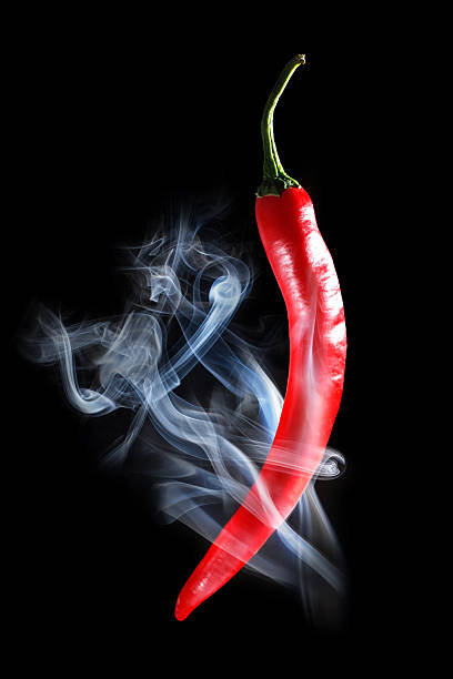 istock Smoking red hot chili Pepper on a black background 533478053