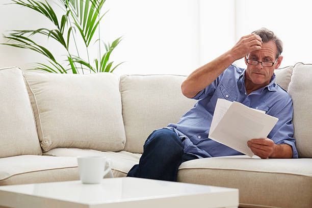istock Mature man at home with bills 533478401