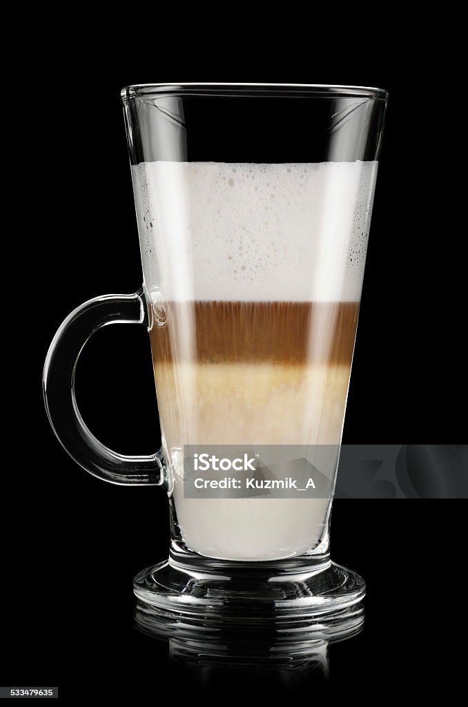 Latte macchiato Glass of latte macchiato over black background 2015 Stock Photo