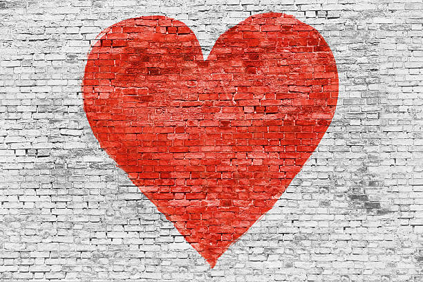 istock Symbol of love painted on brick wall 533480527
