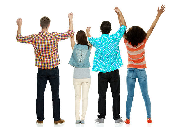 istock Rear view of four people cheering 533481099