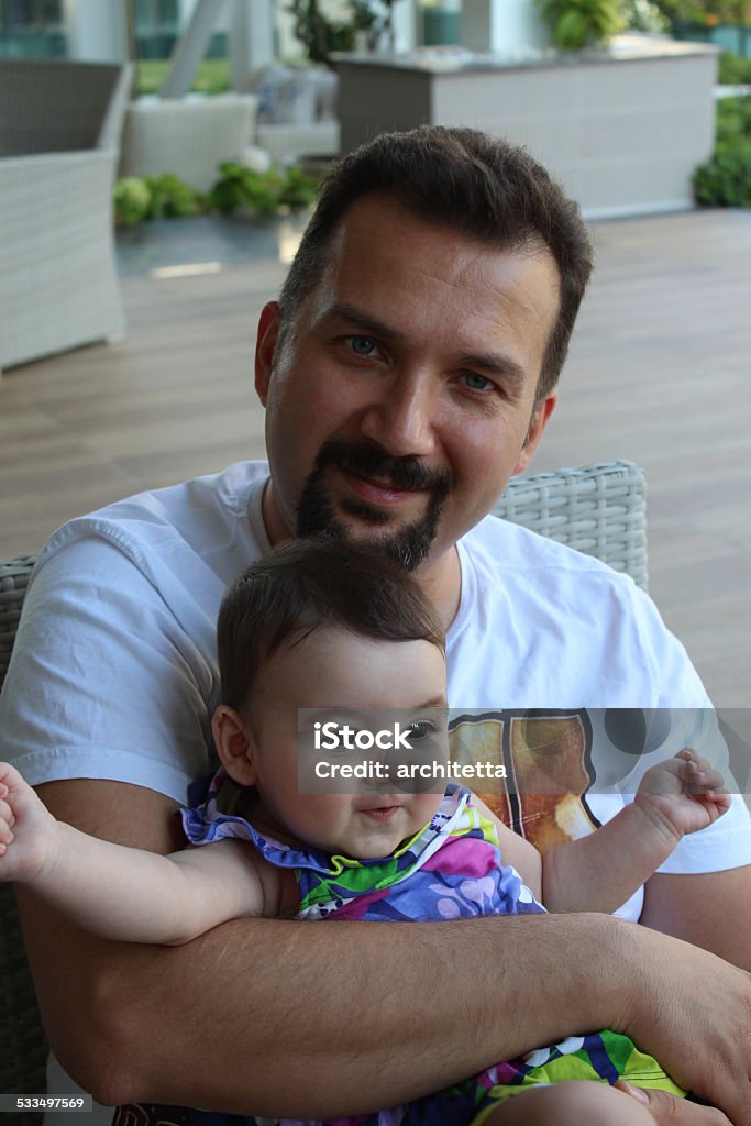 father holding baby father holding 6 months old baby girl 2015 Stock Photo