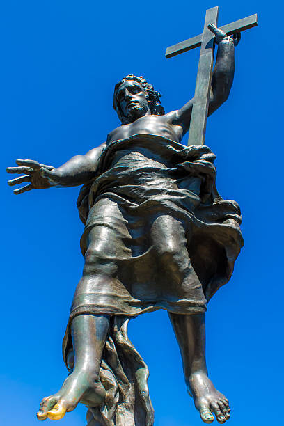 A vertical shot of the Monument to the Sacred Heart of Jesus against a cloudy blue sky in Oviedo, Asturias, Spain