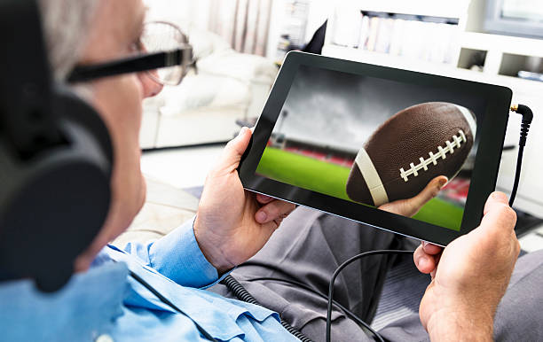 istock Man watching a football game on the tablet 533500063