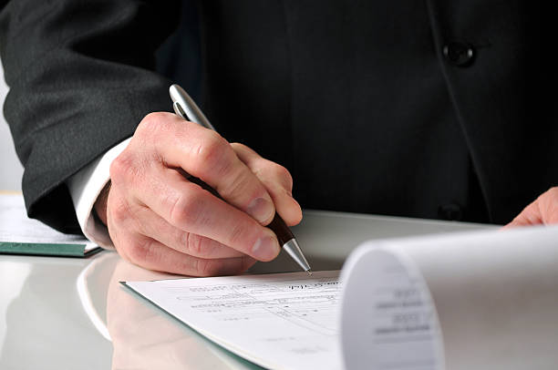 istock Businessman signing papers on a white reflective desk 533500095