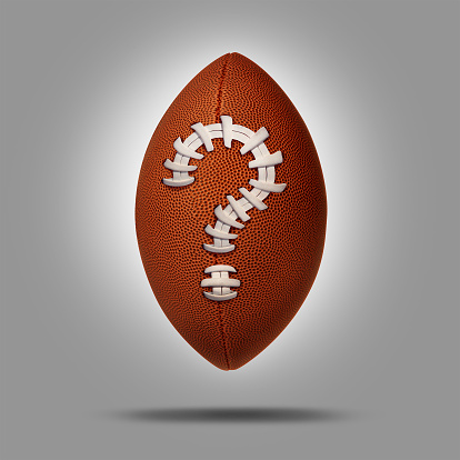 Sports betting concept as an American football with a question mark symbol as a metaphor for sport  match predictions and uncertainty of the final score.