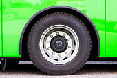 Closeup green bus wheel, full frame horizontal composition