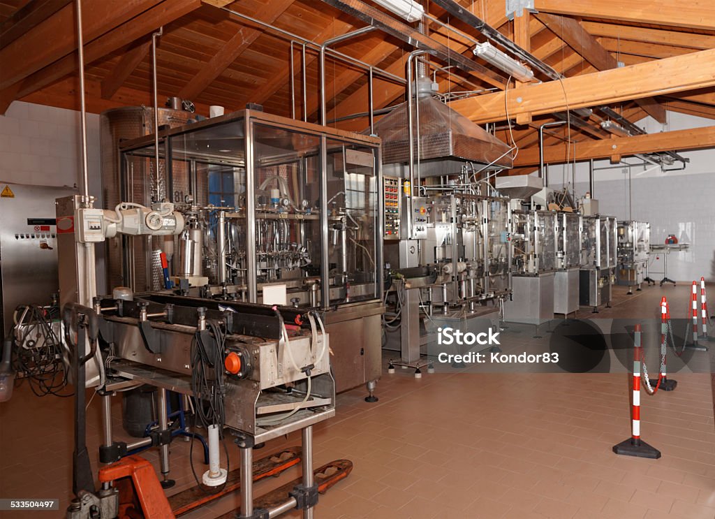 Wine bottling line Wine bottling equipment line in a hangar Factory Stock Photo