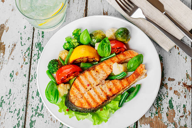 istock steak grilled salmon with vegetables on a plate 533516555