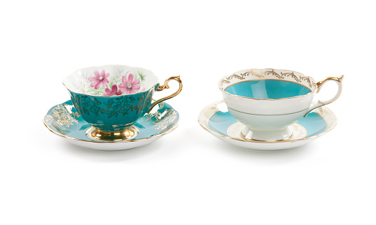 High resolution close-up of two beautiful antique tea cups with saucers.
