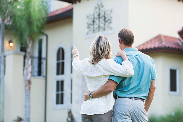 istock Mature couple standing in front of their mansion 533517899