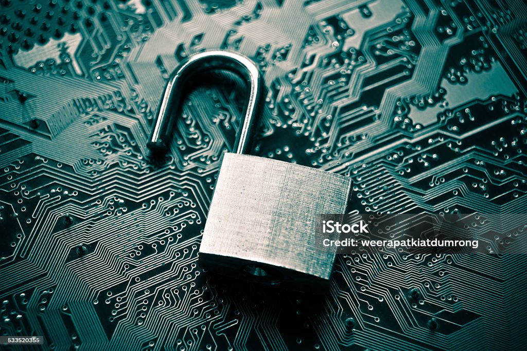 computer security hacked security lock on computer circuit board - computer security breach concept Data Stock Photo