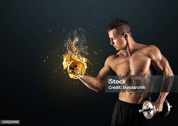 Muscular Man With Dumbbells On Dark Background Stock Photo - Download Image Now - 2015, Activity, Adult