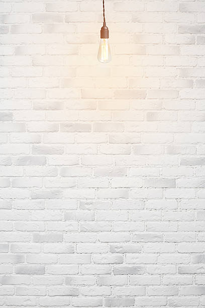 istock white brick wall background with retro lamp 533522803