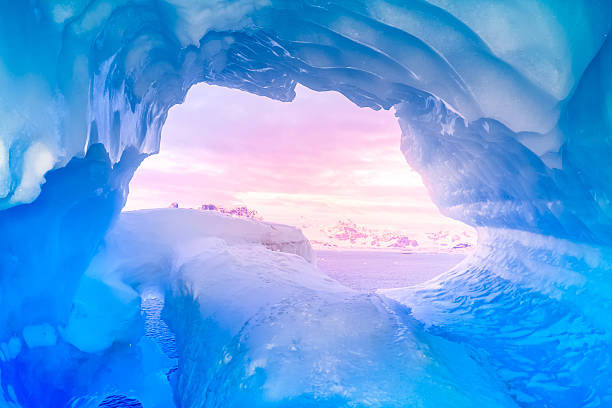 blue ice cave blue ice cave covered with snow and flooded with light stalagmite stock pictures, royalty-free photos & images