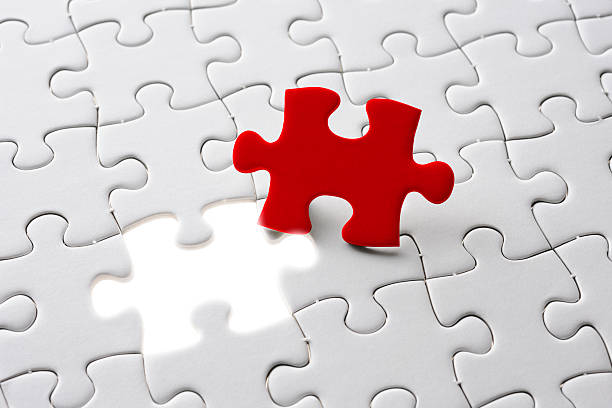 istock Final piece of the red jigsaw with light from behind 533536649
