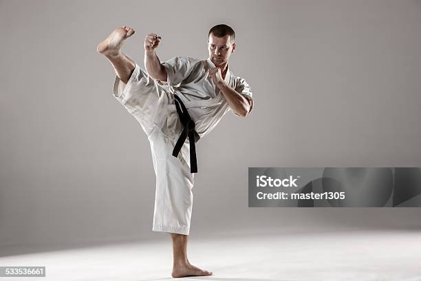 Man In White Kimono Training Karate Stock Photo - Download Image Now - 2015, Active Lifestyle, Activity