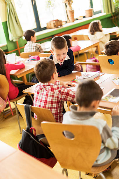 istock Little boys talking in the classroom. 533538211