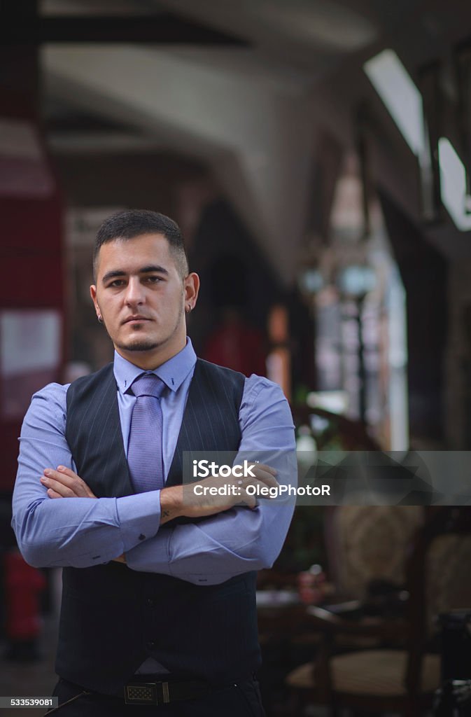 The thoughtful young man in a vest The serious and thoughtful young man in a vest, a tie and with a beard 2015 Stock Photo