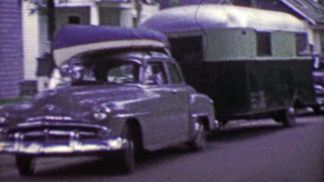 1953: Family truckster car loaded canoe and camping trailer vacation.