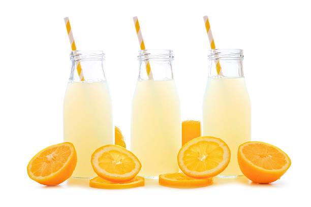 istock Three bottles of lemonade with lemon slices and straws isolated 533551910