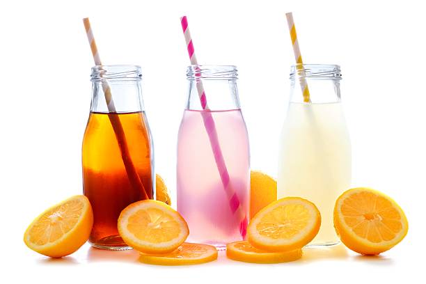 Iced tea, pink lemonade and lemonade in bottles isolated