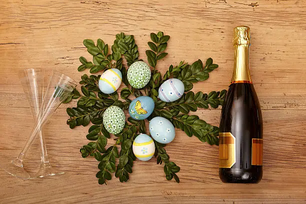 Easter decoration, champagner bootle and champagne glasses on wood