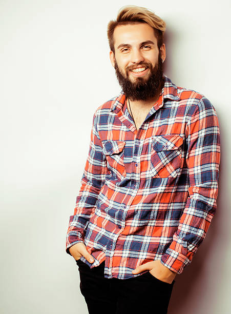 istock portrait of young bearded hipster guy smiling on white background 533553782