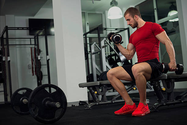 handsome young man in the gym - human muscle muscular build bicep men imagens e fotografias de stock