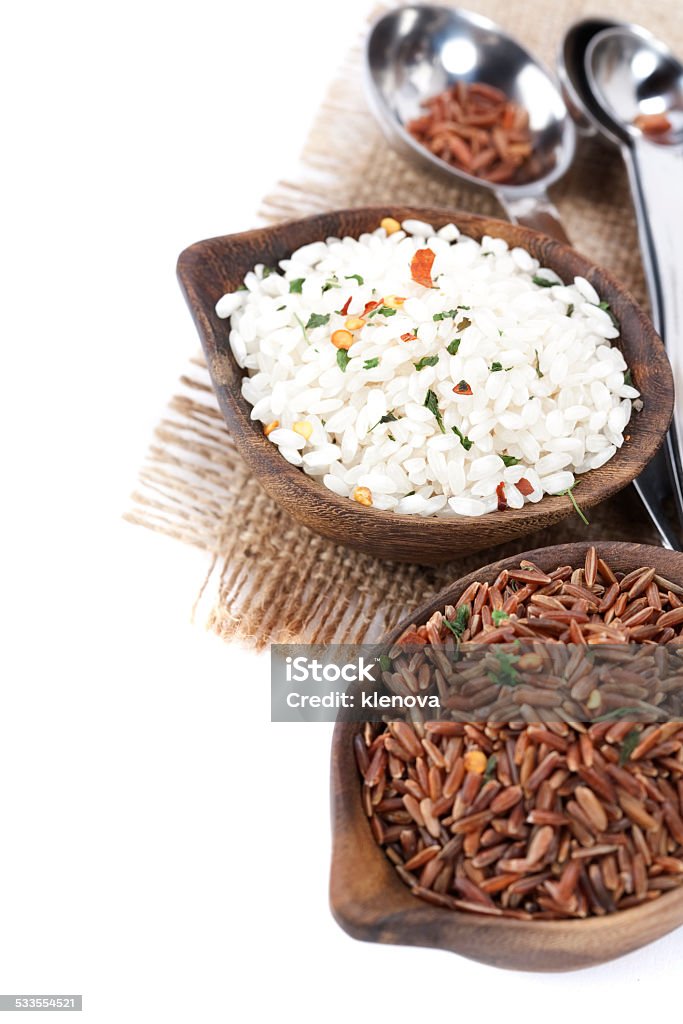 variety of rice Bowls of uncooked rice over white 2015 Stock Photo