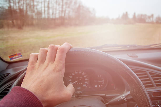 istock Driver's hands on the steering wheel inside of a car 533555576
