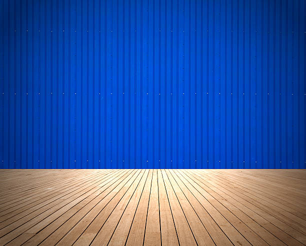 istock Metallic blue wall with wood florring room background 533555812