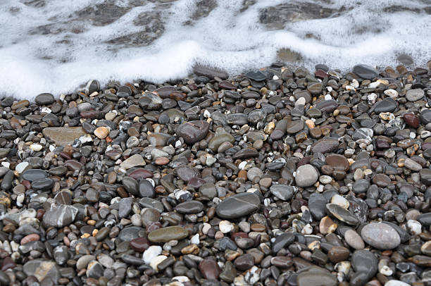istock grey pebbles on the sea shore 533555955
