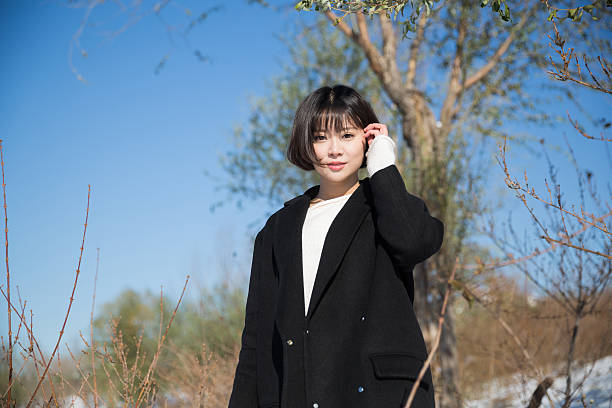 istock girl wearing a black winter coat 533556408
