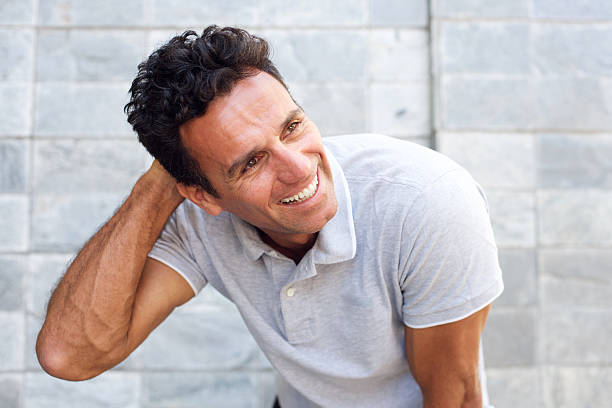 istock Handsome older man laughing with hand in hair 533558308