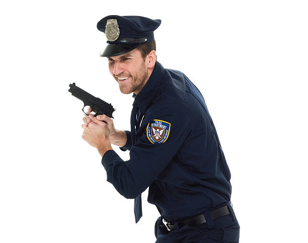 istock Cheerful police in action with gun 533558870