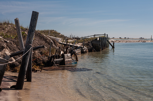 A sandy barrier island in Chatham, Cape Cod, Massachusetts is being eroded away by rising sea levels.